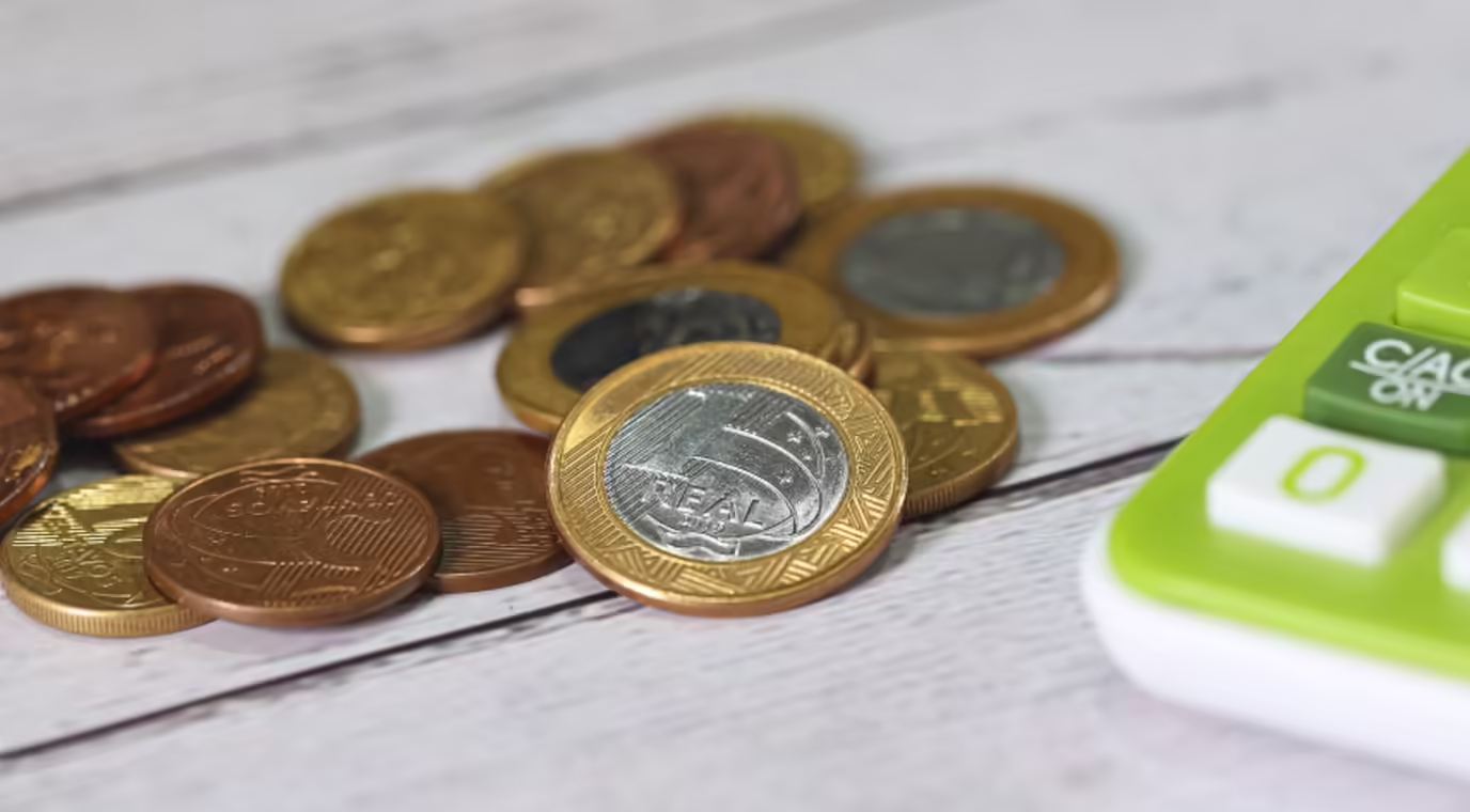 moedas-ao-lado-de-uma-calculadora